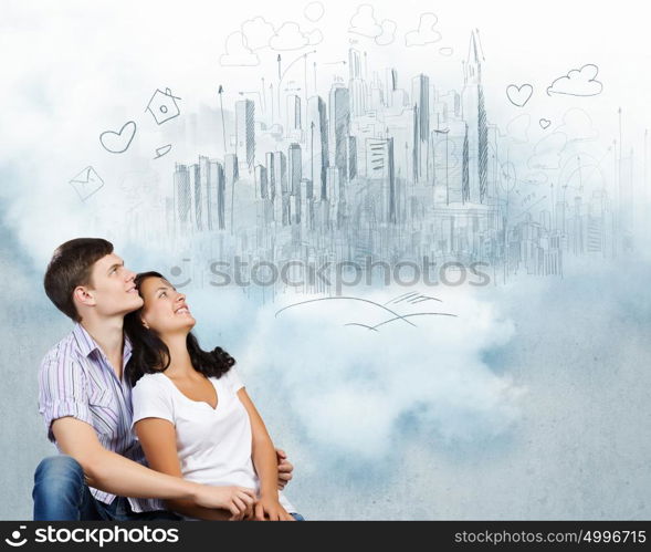 Young family. Young couple hugging each other and dreaming about future