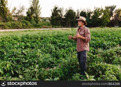 Young farmer man with hat working in his field