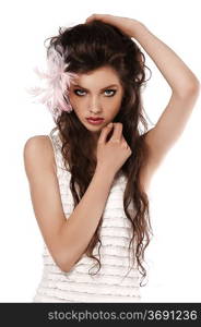 young fashion brunette posing on white wearing a pink feather in her hair
