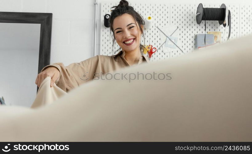 young fashion designer working her workshop alone