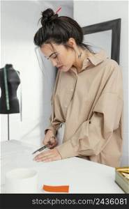 young fashion designer working her workshop alone 3