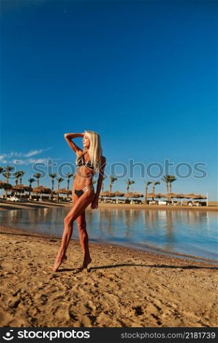 Young fashion woman standing on the beach.. Young fashion woman standing on the beach