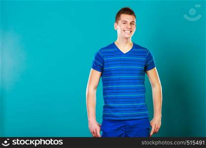 Young fashionable man casual style positive face expression posing on blue