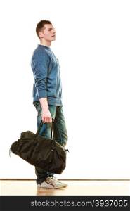 Young fashionable man teen boy in full length casual style blue jeans holding black bag isolated on white