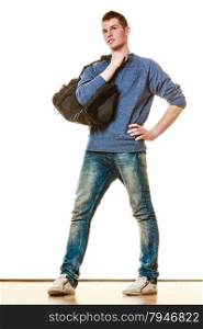 Young fashionable man teen boy in full length casual style blue jeans holding black bag isolated on white