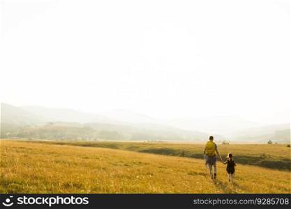Young father and daughter enjoy hiking on a sunny day