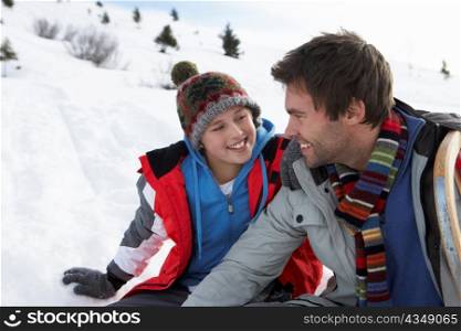 Young Father And Son In Snowy Landscape