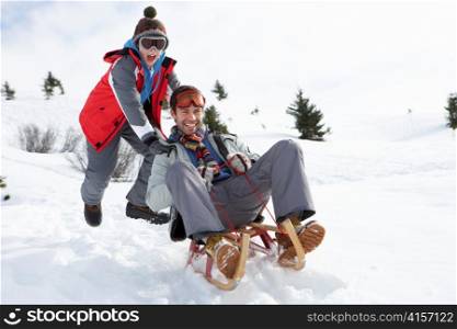 Young Father And Son Sledding