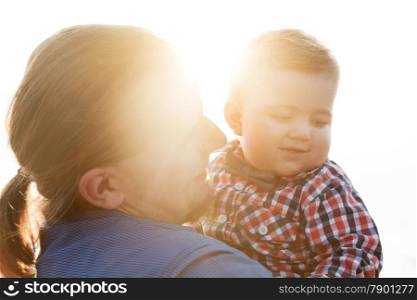 Young father holding his child on the beach, portrait. Son and parent bond