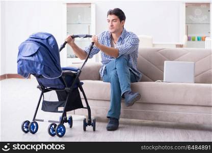 Young father looking after newborn baby at home