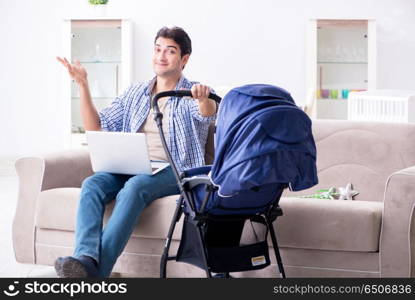 Young father looking after newborn baby at home