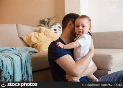 Young father taking care of crying baby