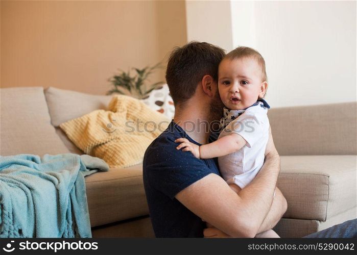 Young father taking care of crying baby