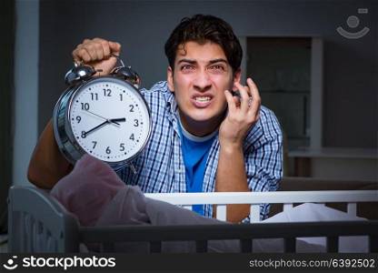 Young father under stress due to baby crying at night