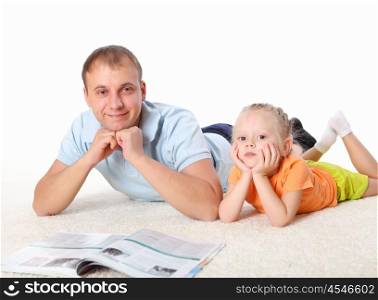 young father with a daughter at home reading a book