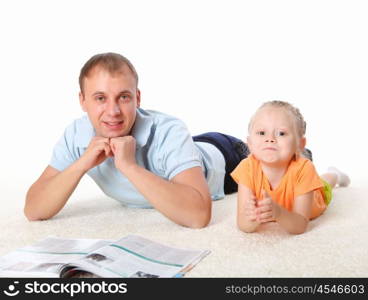 young father with a daughter at home reading a book