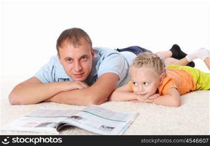 young father with a daughter at home reading a book