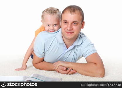 young father with a daughter at home reading a book