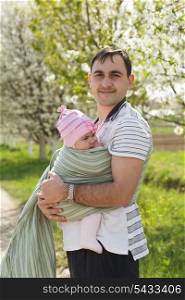 Young father with his five months baby outdoor