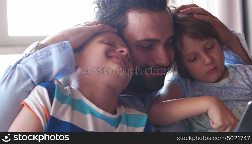 Young Father With Two Kids using technology in modern aprtment