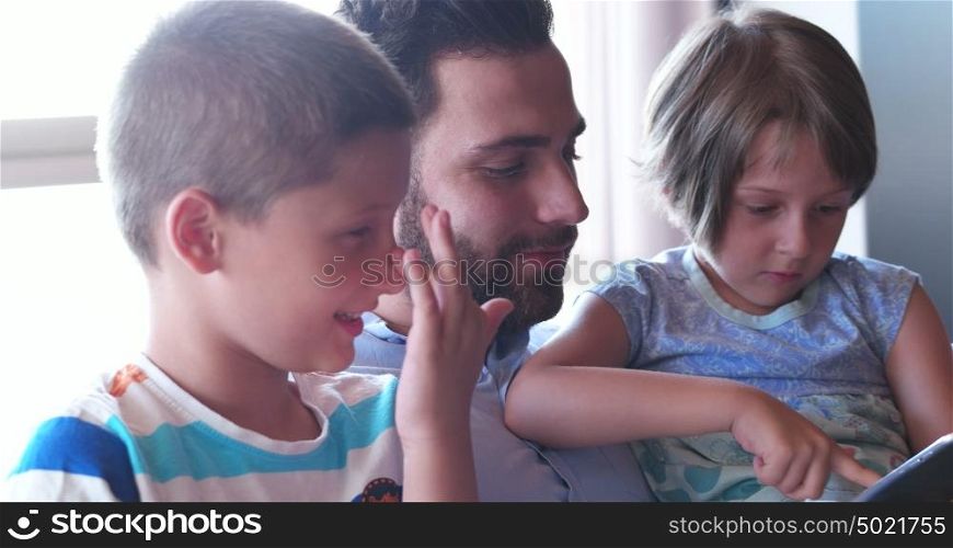Young Father With Two Kids using technology in modern aprtment
