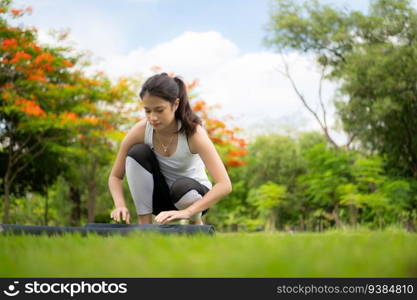 Young fema≤with outdoor activities in the city park, Yoga is her chosen activity.