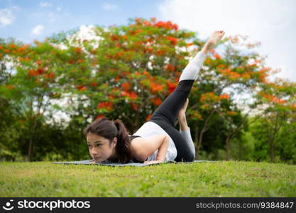 Young fema≤with outdoor activities in the city park, Yoga is her chosen activity.