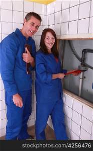 Young female apprentice plumber