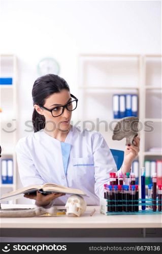 Young female archaeologist working in the lab 