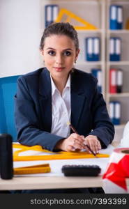 Young female architect working in the office 