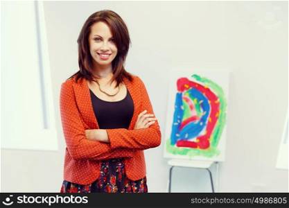 Young female artist with her picture. Young female artist in gallery with her picture