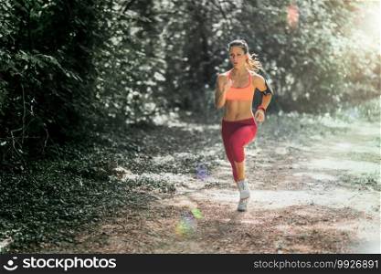 Young female athlete jogging in the park