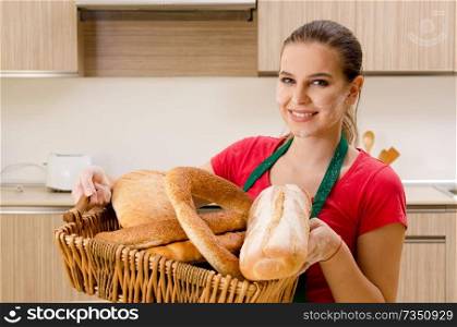 Young female baker working in kitchen 