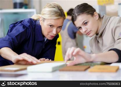 young female carpenter and teacher at work