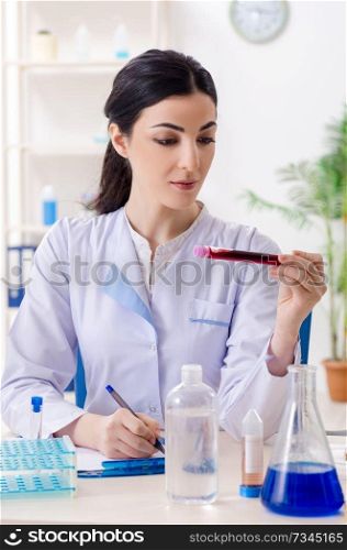 Young female chemist working in the lab 