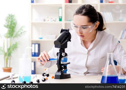 Young female chemist working in the lab 