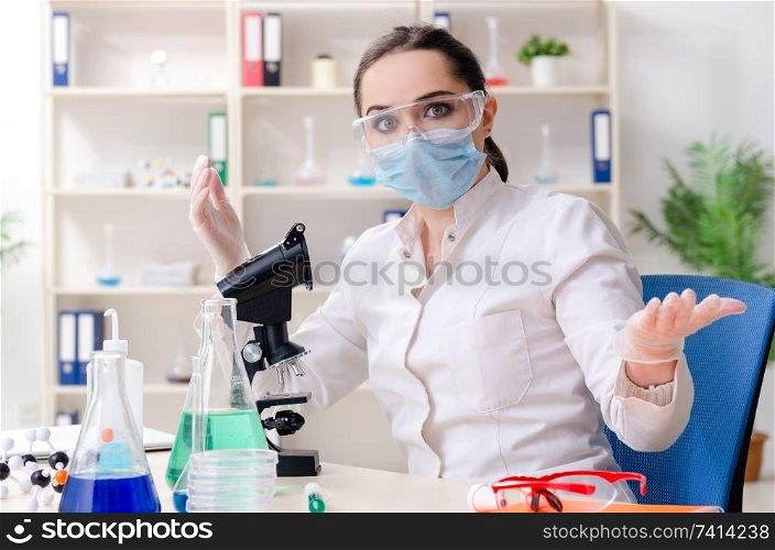 Young female chemist working in the lab 