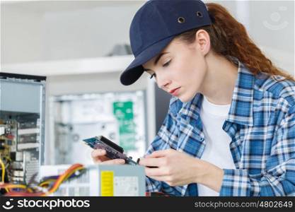 Young female computer repair person