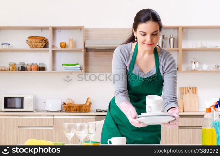 Young female contractor doing housework 