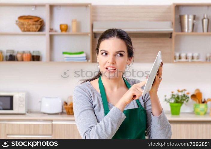 Young female contractor doing housework 