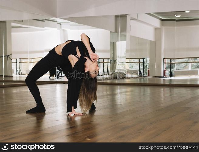 young female dancer practising dance studio