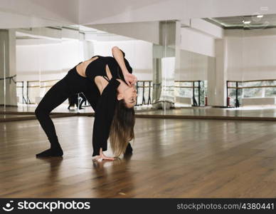 young female dancer practising dance studio