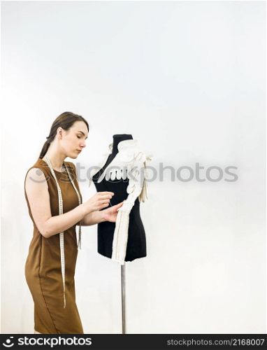young female designer sewing dress shop
