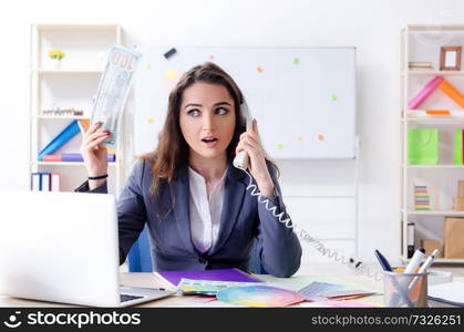 Young female designer working in the office 