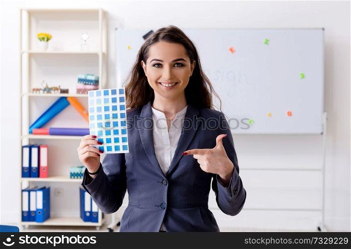 Young female designer working in the office 