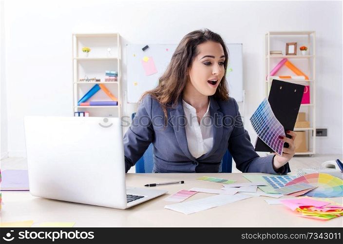 Young female designer working in the office 