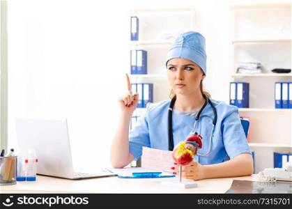Young female doctor cardiologist sitting at the hospital 