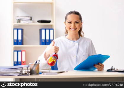 Young female doctor cardiologist sitting at the hospital 