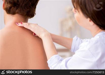 Young female doctor chiropractor massaging male patient