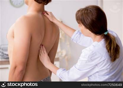 Young female doctor chiropractor massaging male patient